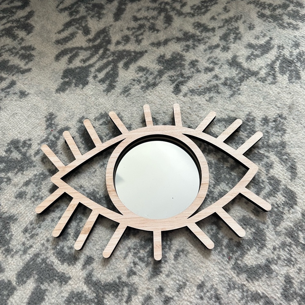 Eye mirror has hooks to hang
